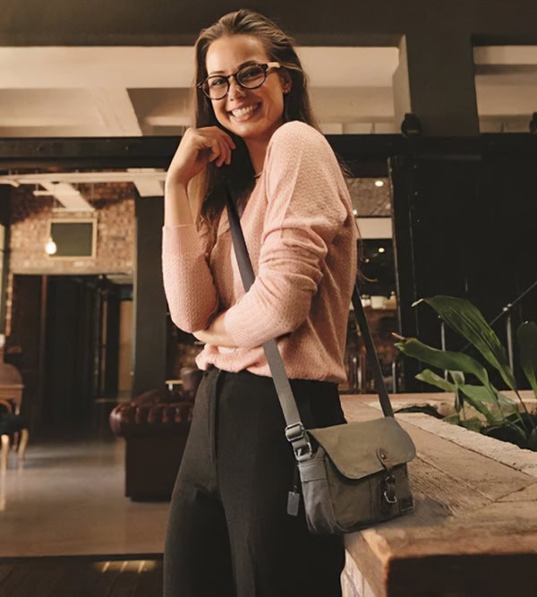 Troop London crossbody bag worn over the shoulder